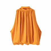 Women’s bow-tie front blouse in vibrant orange, cropped and sleeveless.