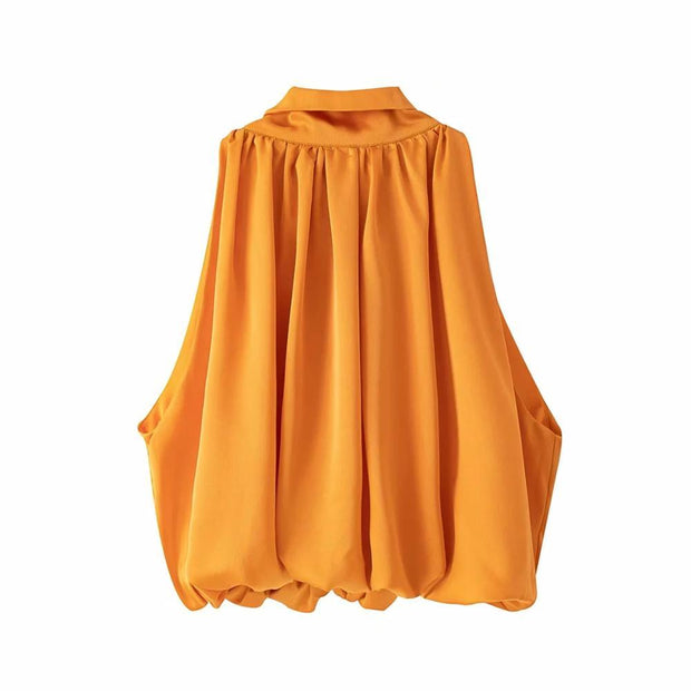 Women’s bow-tie front blouse in vibrant orange, cropped and sleeveless.