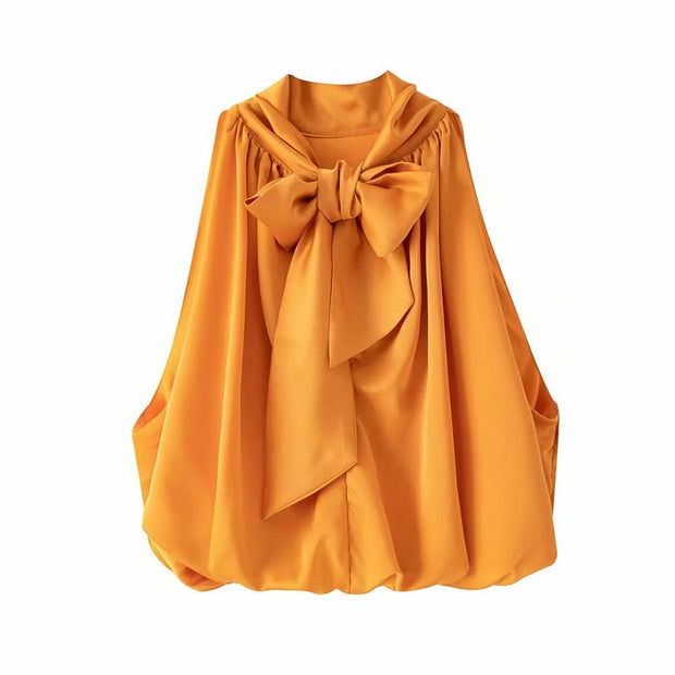 Women’s bow-tie front blouse in vibrant orange, cropped and sleeveless.