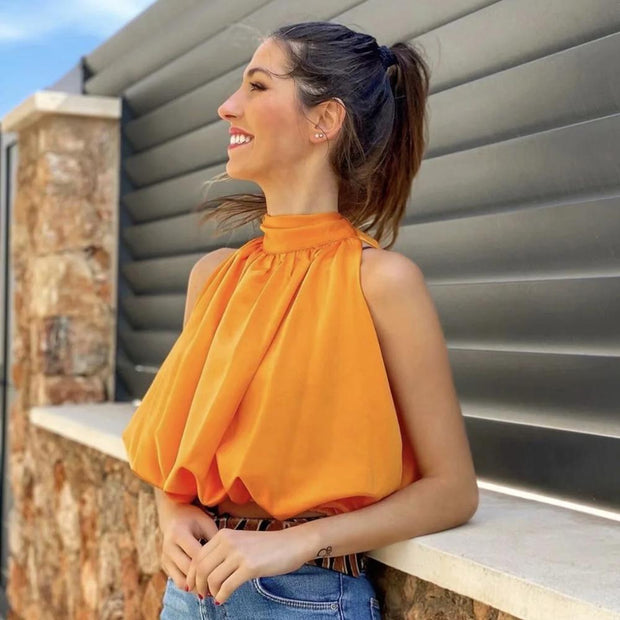 Women’s bow-tie front blouse in vibrant orange, cropped and sleeveless.