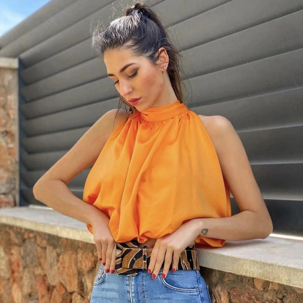 Women’s bow-tie front blouse in vibrant orange, cropped and sleeveless.