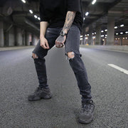 Men’s distressed skinny jeans in grey, perfect for street style.