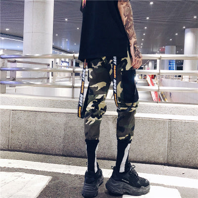 Men’s camo jogger pants with strap details, green urban streetwear.